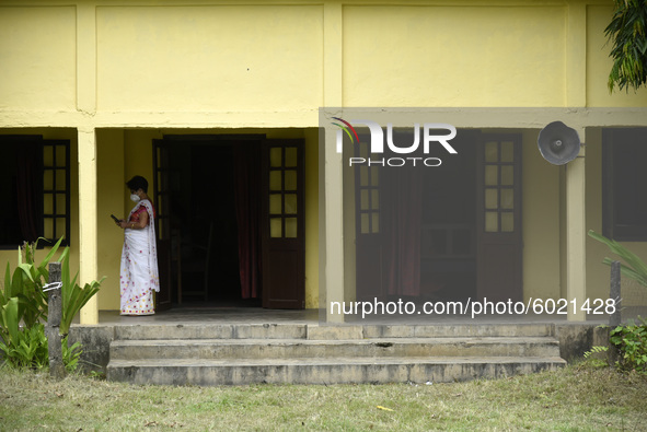 A teacher arrives  at a school, in Guwahati, Assam, India on September 21, 2020 as schools reopened after more than 5-months closure due to...