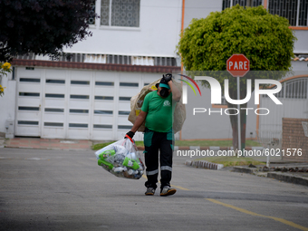 Mr. Botache belongs to the group of Environmental Recuperators walks through the streets of the town of San Cristobal on a collection day in...