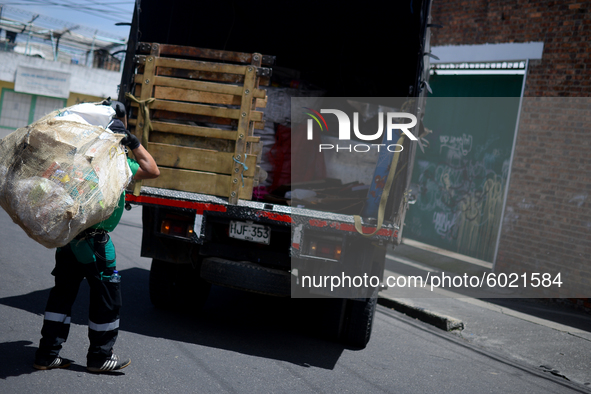 A worker loads the recycled material into the truck during a working day in the town of San Cristóbal, in Bogota, Colombia on September 9, 2...