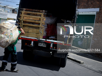 A worker loads the recycled material into the truck during a working day in the town of San Cristóbal, in Bogota, Colombia on September 9, 2...