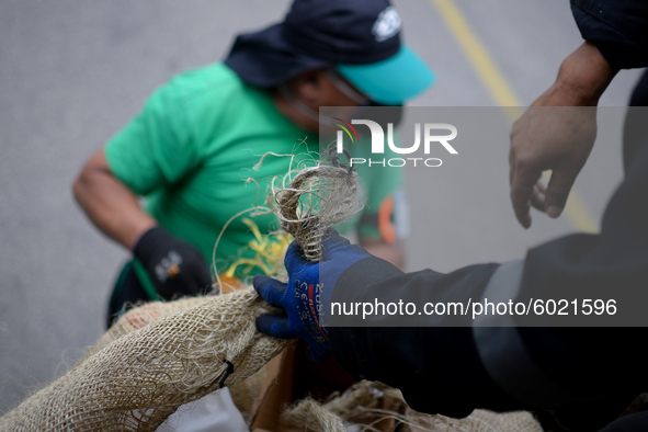 A worker loads the recycled material into the truck during a working day in the town of San Cristóbal, in Bogota, Colombia on September 9, 2...