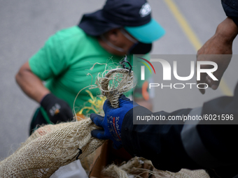 A worker loads the recycled material into the truck during a working day in the town of San Cristóbal, in Bogota, Colombia on September 9, 2...