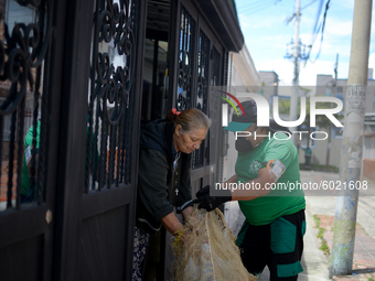 Mr. Botache belongs to the group of Environmental Recuperators walks through the streets of the town of San Cristobal on a collection day in...