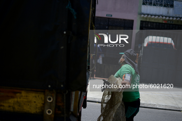 A worker loads the recycled material into the truck during a working day in the town of San Cristóbal, in Bogota, Colombia on September 9, 2...