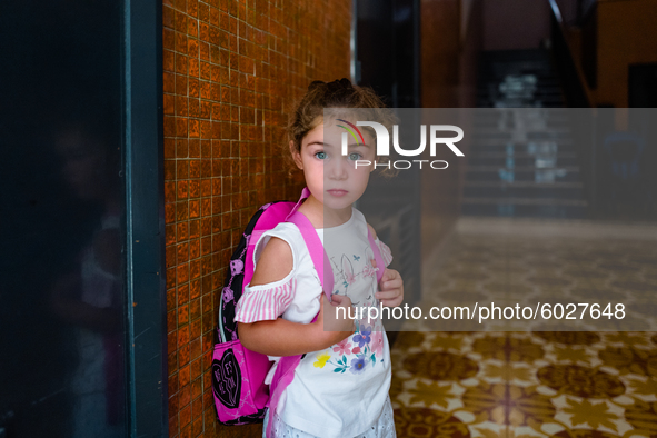 A little girl waiting to go to school, on the first day, waits for her mother down at the front door, in Molfetta, Italy, on 24 September 20...