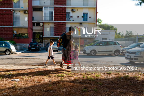 The mother with her children on their way to school, on the first day of school in Molfetta on 24 September 2020.
The return to school for...