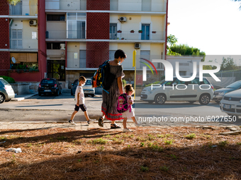 The mother with her children on their way to school, on the first day of school in Molfetta on 24 September 2020.
The return to school for...