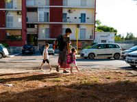 The mother with her children on their way to school, on the first day of school in Molfetta on 24 September 2020.
The return to school for...