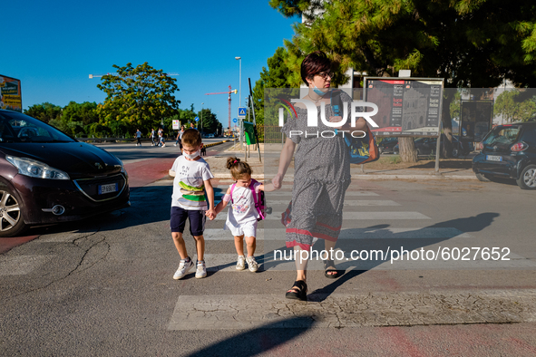 The mother with her children on their way to school, on the first day of school in Molfetta on 24 September 2020.
The return to school for...