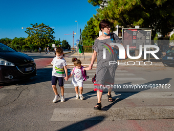 The mother with her children on their way to school, on the first day of school in Molfetta on 24 September 2020.
The return to school for...