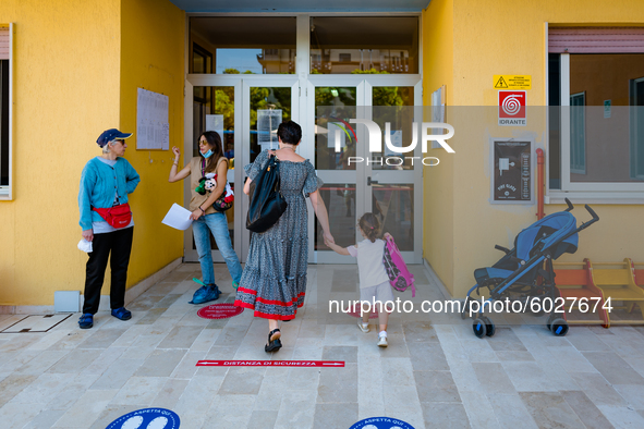 A little girl enters kindergarten with her mother on the first day of school in Molfetta on 24 September 2020.
The return to school for chi...