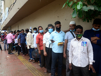 Bangladeshi migrant workers who work in Saudi Arabia gather in front of the Biman Bangladesh Airlines office to collect air tickets to go ba...