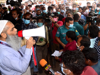 Bangladeshi migrant workers who work in Saudi Arabia gather in front of the Biman Bangladesh Airlines office to collect air tickets to go ba...