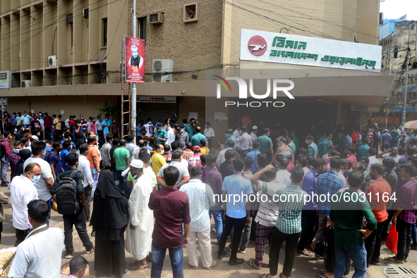 Bangladeshi migrant workers who work in Saudi Arabia gather in front of the Biman Bangladesh Airlines office to collect air tickets to go ba...