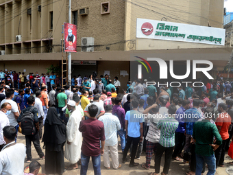 Bangladeshi migrant workers who work in Saudi Arabia gather in front of the Biman Bangladesh Airlines office to collect air tickets to go ba...