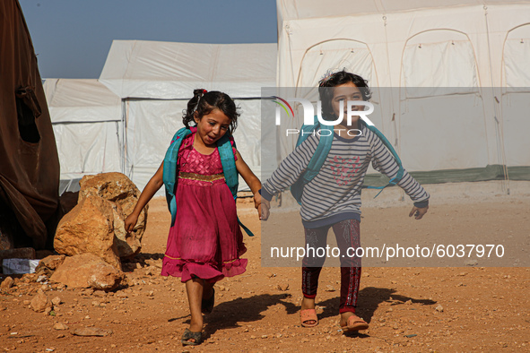 Syrian students play in front of their school tent on the first day of the new school year near the city of Maarat Misreen in Idlib countrys...