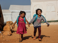 Syrian students play in front of their school tent on the first day of the new school year near the city of Maarat Misreen in Idlib countrys...