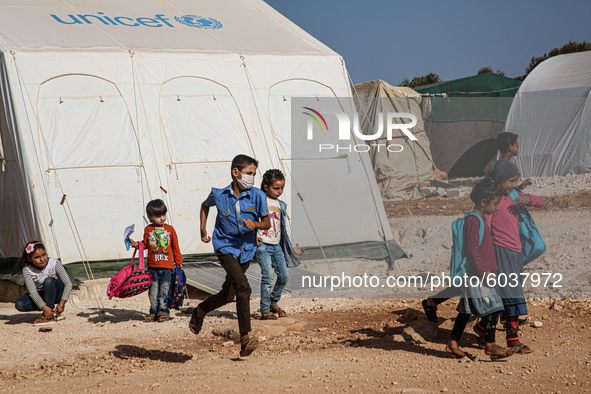 Syrian students play in front of their school tent on the first day of the new school year near the city of Maarat Misreen in Idlib countrys...