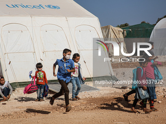 Syrian students play in front of their school tent on the first day of the new school year near the city of Maarat Misreen in Idlib countrys...