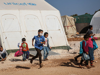 Syrian students play in front of their school tent on the first day of the new school year near the city of Maarat Misreen in Idlib countrys...