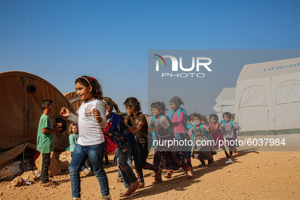 Syrian students play in front of their school tent on the first day of the new school year near the city of Maarat Misreen in Idlib countrys...