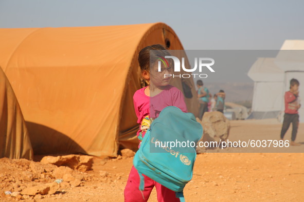 Syrian students play in front of their school tent on the first day of the new school year near the city of Maarat Misreen in Idlib countrys...