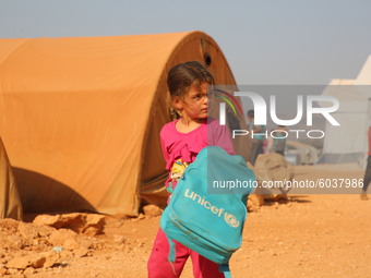 Syrian students play in front of their school tent on the first day of the new school year near the city of Maarat Misreen in Idlib countrys...