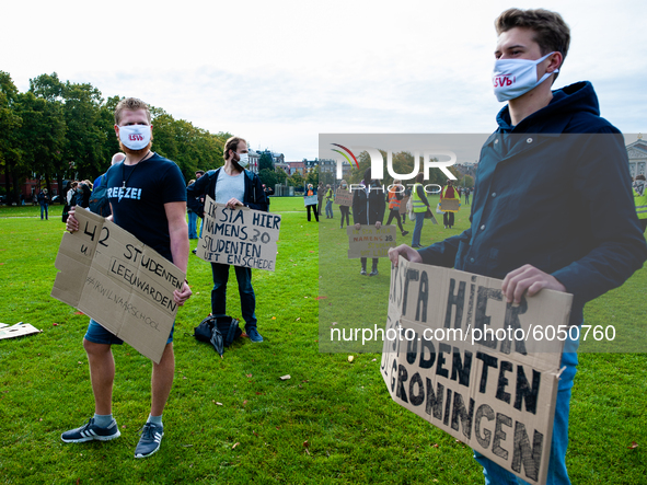 Several students are holding placards in representation of other students during the students protest for more physical attendance classes,...