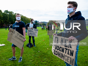 Several students are holding placards in representation of other students during the students protest for more physical attendance classes,...