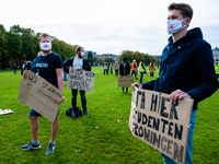 Several students are holding placards in representation of other students during the students protest for more physical attendance classes,...