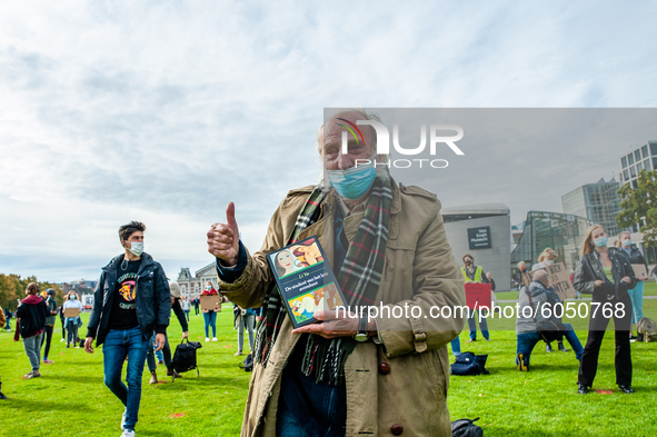 An old man is holding a book during the students protest for more physical attendance classes, in Amsterdam, Netherlands on October 2nd, 202...