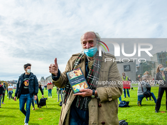 An old man is holding a book during the students protest for more physical attendance classes, in Amsterdam, Netherlands on October 2nd, 202...