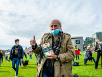 An old man is holding a book during the students protest for more physical attendance classes, in Amsterdam, Netherlands on October 2nd, 202...