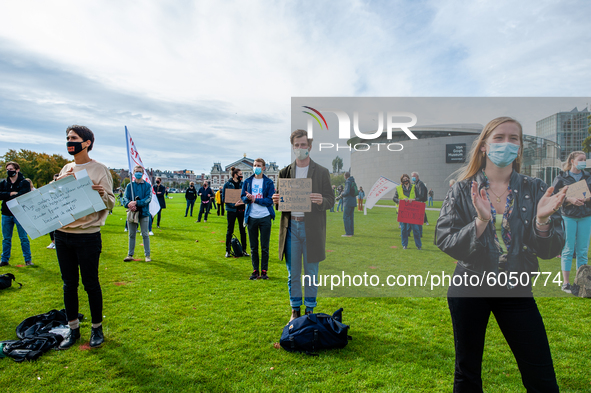 Several students are holding placards in representation of other students during the students protest for more physical attendance classes,...