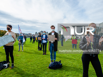 Several students are holding placards in representation of other students during the students protest for more physical attendance classes,...