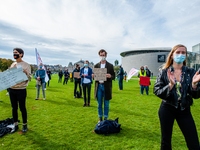 Several students are holding placards in representation of other students during the students protest for more physical attendance classes,...