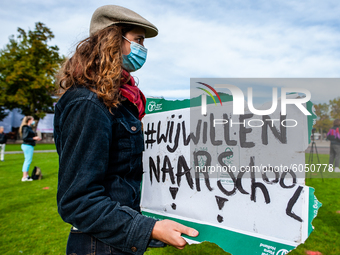 A woman is holding a placard that says I want back to school, during the students protest for more physical attendance classes, in Amsterdam...