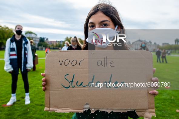 A little girl is holding a placard that says I want back to school, during the students protest for more physical attendance classes, in Ams...