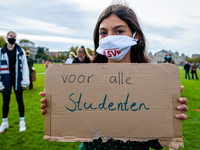 A little girl is holding a placard that says I want back to school, during the students protest for more physical attendance classes, in Ams...