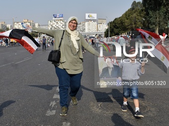Supporters of Egyptian President Abdel Fattah al-Sisi dance and wave flags during, held on the occasion the 6th of October war anniversary,...