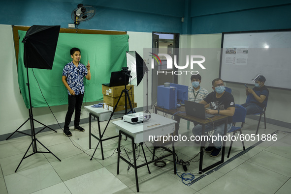 Teachers make use of green screen in filming lectures in preparation for the opening of classes at a school in Valenzuela City in Metro Mani...