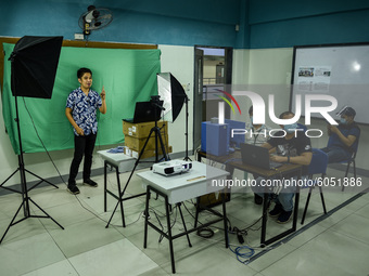 Teachers make use of green screen in filming lectures in preparation for the opening of classes at a school in Valenzuela City in Metro Mani...