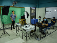 Teachers make use of green screen in filming lectures in preparation for the opening of classes at a school in Valenzuela City in Metro Mani...