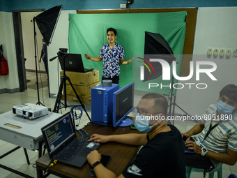 Teachers make use of green screen in filming lectures in preparation for the opening of classes at a school in Valenzuela City in Metro Mani...