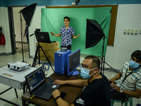 Teachers make use of green screen in filming lectures in preparation for the opening of classes at a school in Valenzuela City in Metro Mani...