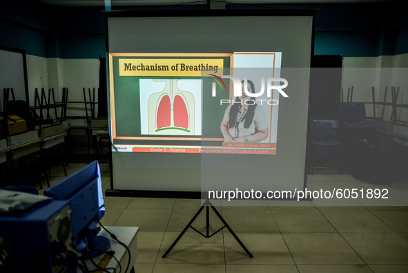 A class lecture is projected on a screen as teachers prepare for the opening of classes at a school in Valenzuela City in Metro Manila, Phil...