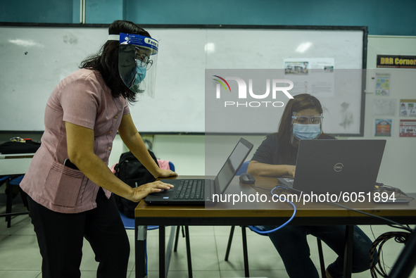 Teachers prepare online lectures for the opening of classes at a school in Valenzuela City in Metro Manila, Philippines on October 2, 2020....