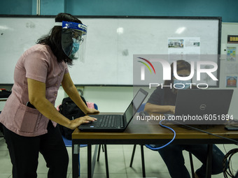 Teachers prepare online lectures for the opening of classes at a school in Valenzuela City in Metro Manila, Philippines on October 2, 2020....