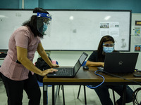 Teachers prepare online lectures for the opening of classes at a school in Valenzuela City in Metro Manila, Philippines on October 2, 2020....