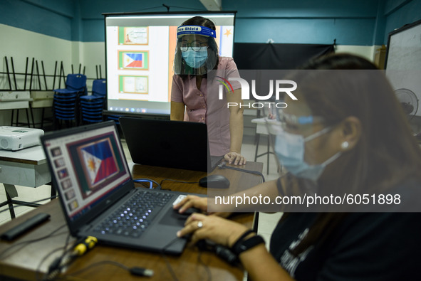 Teachers prepare online lectures for the opening of classes at a school in Valenzuela City in Metro Manila, Philippines on October 2, 2020....